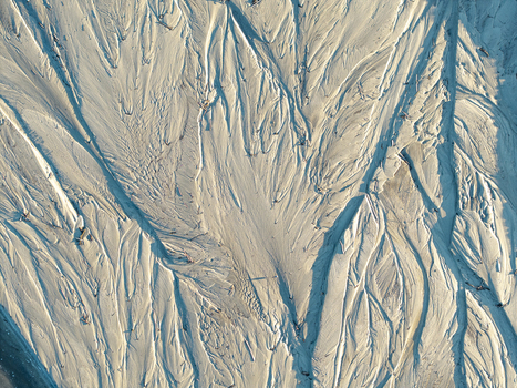 Aerial view of abstract sand textures and river water patterns forming intricate natural shapes in Poland. Aerial view of abstract sand textures and river water patterns forming intricate natural shapes in Poland.