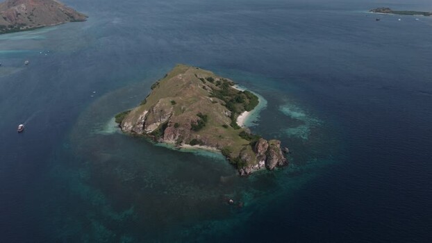 Aerial view of Komodo Island surrounded by turquoise waters Indonesia.