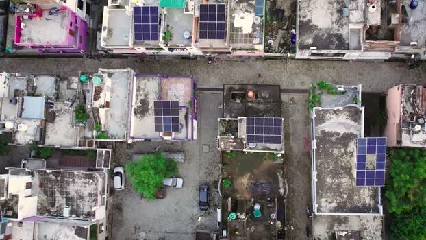 Aerial view of solar panels on residential rooftops in India.