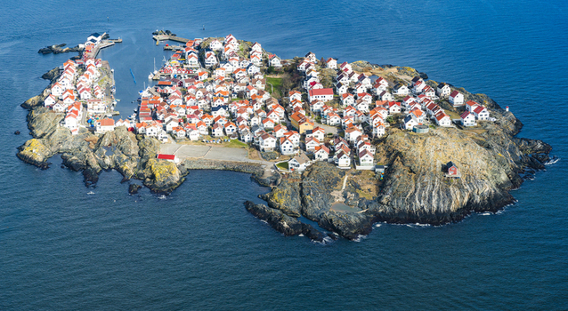 Aerial view of the village of Astol with white houses and red roofs on rocky terrain surrounded by the sea in Astol Vastra Gotaland County Sweden.