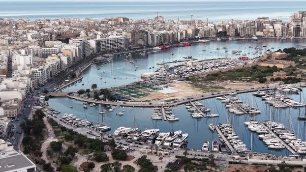 Aerial view of yachts in a marina and urban buildings Malta. Aerial view of yachts in a marina and urban buildings Malta.
