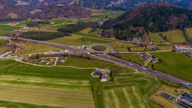 Aerial view of the valley s patchwork fields and winding roads contrast against the backdrop of the majestic mountains Windischgarsten Upper Austria Austria. Aerial view of the valley s patchwork fields and winding roads contrast against the backdrop of the majestic mountains Windischgarsten Upper Austria Austria.