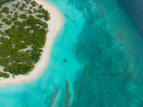 Aerial view of the radiant turquoise waters embracing the pristine white sands and verdant greenery of the tropical island Hoarafushi Thiladhunmathee Uthuruburi Maldives. Aerial view of the radiant turquoise waters embracing the pristine white sands and verdant greenery of the tropical island Hoarafushi Thiladhunmathee Uthuruburi Maldives.