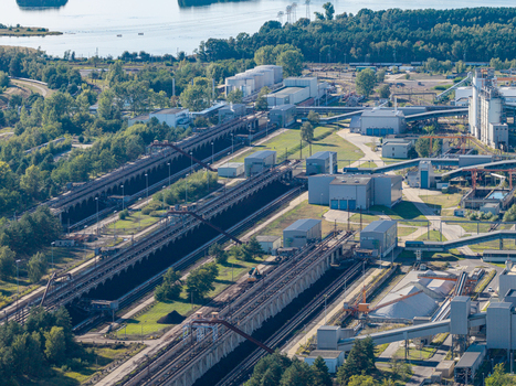 Aerial view of the Janschwalde Power Station showing industrial infrastructure coal conveyor belts and storage facilities surrounded by forest in Peitz Brandenburg Germany. Aerial view of the Janschwalde Power Station showing industrial infrastructure coal conveyor belts and storage facilities surrounded by forest in Peitz Brandenburg Germany.