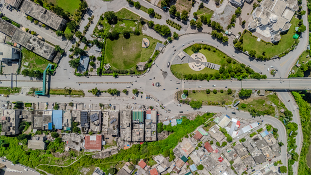 Aerial view of the urban intersection with surrounding buildings roads and green spaces in Muzaffarabad Azad Kashmir Pakistan. Aerial view of the urban intersection with surrounding buildings roads and green spaces in Muzaffarabad Azad Kashmir Pakistan.