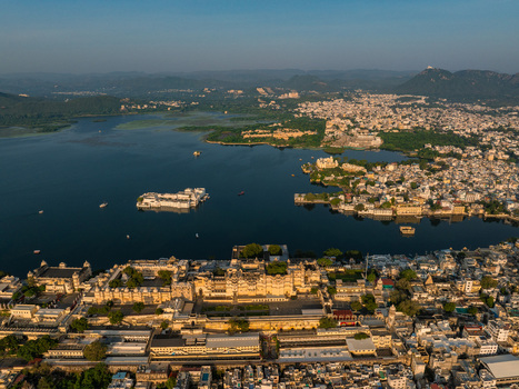 Aerial view of the historic City Palace complex situated on the banks of Lake Pichola in Udaipur Rajasthan India.