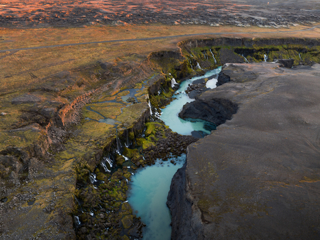 Aerial view of turquoise waters carve through the rugged moss strewn canyon walls revealing the raw beauty of Iceland s untamed landscapes Sigöldugljúfur Rangárþing ytra Iceland. Aerial view of turquoise waters carve through the rugged moss strewn canyon walls revealing the raw beauty of Iceland s untamed landscapes Sigöldugljúfur Rangárþing ytra Iceland.
