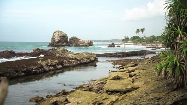 View of rocky coastline and ocean waves at Koggala beach Sri Lanka.