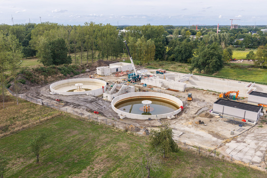 Diepenbeek Flanders Belgium 30 August 2026 Aerial view of a wastewater treatment plant under construction with circular concrete tanks a crane and industrial infrastructure. Diepenbeek Flanders Belgium 30 August 2026 Aerial view of a wastewater treatment plant under construction with circular concrete tanks a crane and industrial infrastructure.