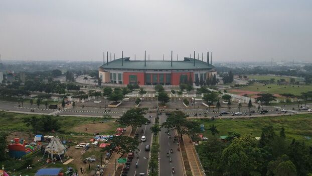Aerial view of Pakansari Stadium surrounded by lush greenery roads and urban infrastructure in Kecamatan Cibinong Jawa Barat Indonesia. Aerial view of Pakansari Stadium surrounded by lush greenery roads and urban infrastructure in Kecamatan Cibinong Jawa Barat Indonesia.