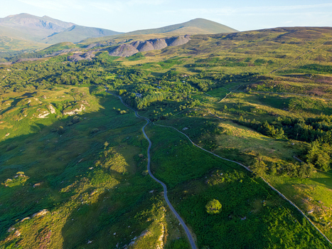 Aerial view of the rolling green hills and winding road Cwm y glo Wales United Kingdom. Aerial view of the rolling green hills and winding road Cwm y glo Wales United Kingdom.