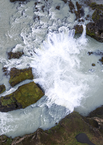 Aerial view of Godafoss Waterfall with powerful white water cascading over dark mossy volcanic rocks in THingeyjarsveit Iceland. Aerial view of Godafoss Waterfall with powerful white water cascading over dark mossy volcanic rocks in THingeyjarsveit Iceland.