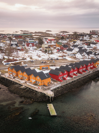 Aerial view of colorful houses contrast against the snow dusted landscape creating a picturesque scene of Nordic charm Ballstad Nordland Norway. Aerial view of colorful houses contrast against the snow dusted landscape creating a picturesque scene of Nordic charm Ballstad Nordland Norway.