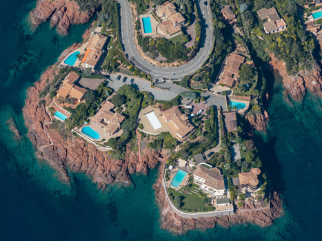 Aerial view of Le Trayas showing luxury villas with swimming pools nestled on the rocky red coastline of the Mediterranean Sea in Saint Raphael Provence Alpes Cote d Azur France. Aerial view of Le Trayas showing luxury villas with swimming pools nestled on the rocky red coastline of the Mediterranean Sea in Saint Raphael Provence Alpes Cote d Azur France.