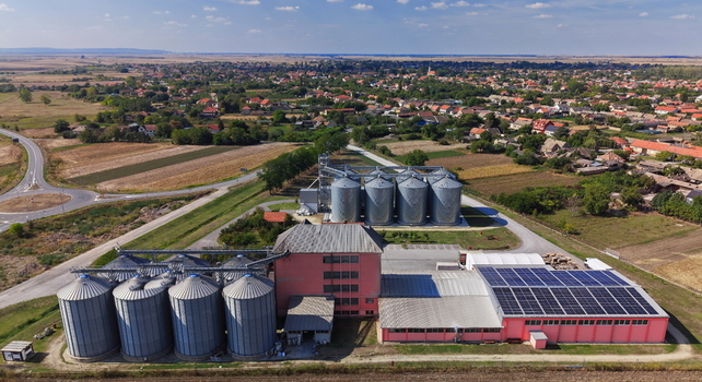 Aerial view of the grain storage silos and industrial facility with solar panels in the rural landscape of Bavaniste Vojvodina Serbia.