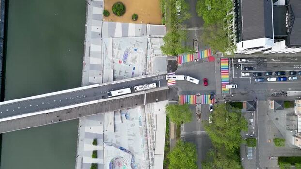 Aerial view of a bus crossing a bridge and rainbow streets Belgium.