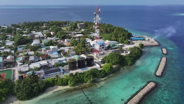 Aerial view of a telecommunications tower and island village Maldives. Aerial view of a telecommunications tower and island village Maldives.
