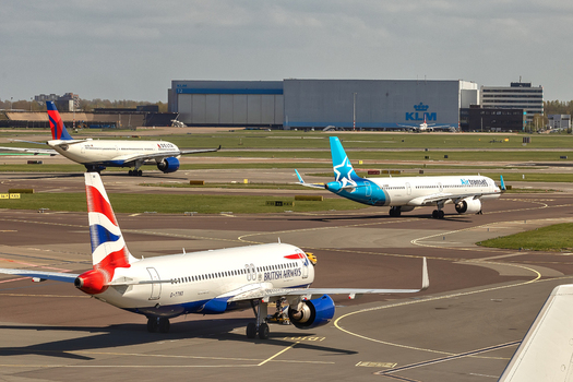 Schiphol Netherlands 16 April 2026 View of British Airways Air Transat and Delta airplanes taxiing on the tarmac at Schiphol Airport with a KLM hangar in the background. Schiphol Netherlands 16 April 2026 View of British Airways Air Transat and Delta airplanes taxiing on the tarmac at Schiphol Airport with a KLM hangar in the background.