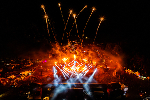 Herzogenaurach Germany 27 July 2025 Aerial view of Open Beatz Festival with fireworks exploding over the main stage bright lights and a Ferris wheel at night. Herzogenaurach Germany 27 July 2025 Aerial view of Open Beatz Festival with fireworks exploding over the main stage bright lights and a Ferris wheel at night.