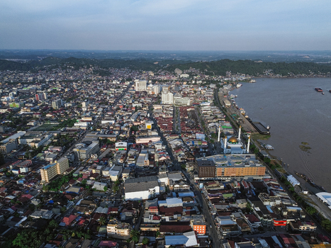 Aerial view of the Samarinda Islamic Center with its golden dome near the Mahakam River surrounded by dense urban buildings and rooftops in Samarinda Kalimantan Timur Indonesia. Aerial view of the Samarinda Islamic Center with its golden dome near the Mahakam River surrounded by dense urban buildings and rooftops in Samarinda Kalimantan Timur Indonesia.