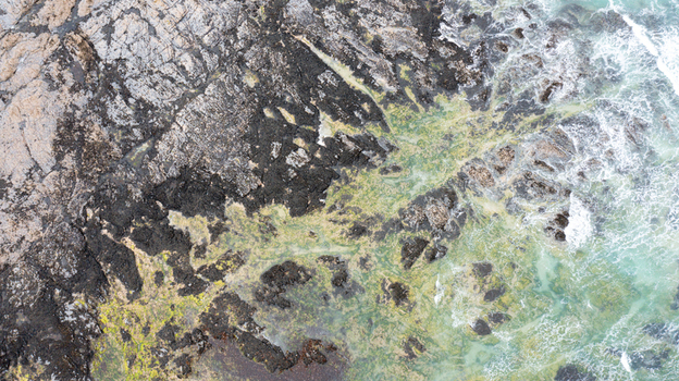 Aerial view of the rugged rocky coastline and turquoise waters at Constantine Bay in Padstow Cornwall United Kingdom. Aerial view of the rugged rocky coastline and turquoise waters at Constantine Bay in Padstow Cornwall United Kingdom.