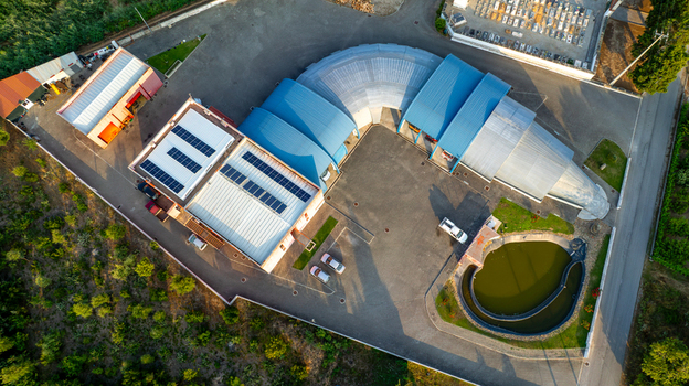 Vila Nova de Oliveirinha Portugal Aerial view of the Bombeiros Voluntarios fire station with its unique curved roof structure like a fire hose adjacent pond and surrounding rural landscape. Vila Nova de Oliveirinha Portugal Aerial view of the Bombeiros Voluntarios fire station with its unique curved roof structure like a fire hose adjacent pond and surrounding rural landscape.