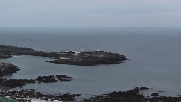 Aerial view of Lofoten lighthouse on a rocky outcrop Norway.