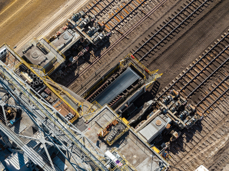 Aerial view of the Tagebau Welzow Sud brown coal open pit mine featuring industrial conveyor belts and railway tracks for heavy machinery in Spremberg Brandenburg Germany. Aerial view of the Tagebau Welzow Sud brown coal open pit mine featuring industrial conveyor belts and railway tracks for heavy machinery in Spremberg Brandenburg Germany.