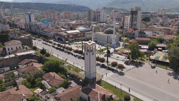Aerial view of the Clock Tower of Elbasan surrounded by the historic old town modern buildings and the nearby mosque in Elbasan Qarku i Elbasanit Albania.
