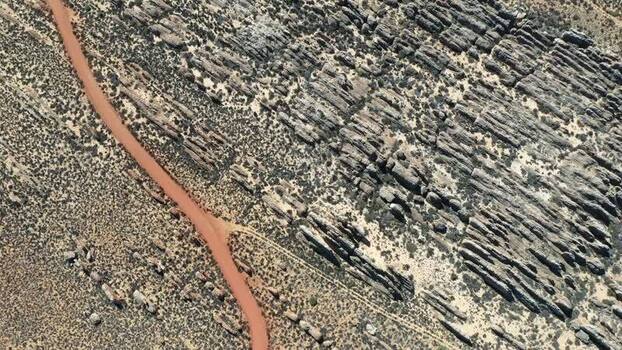 Aerial view of car on red dirt road in Cederberg South Africa.