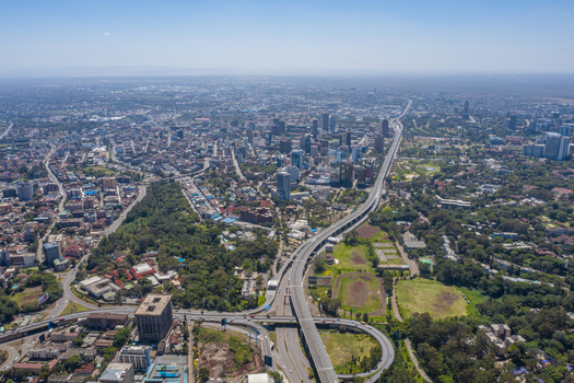 Aerial view of the Westlands district featuring modern skyscrapers dense urban infrastructure and lush green spaces in Nairobi Nairobi County Kenya. Aerial view of the Westlands district featuring modern skyscrapers dense urban infrastructure and lush green spaces in Nairobi Nairobi County Kenya.