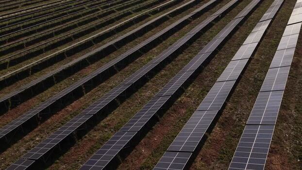 Aerial view of rows of solar panels in a solar farm Portugal. Aerial view of rows of solar panels in a solar farm Portugal.