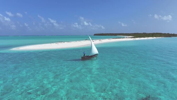 Aerial view of a traditional dhoni boat sailing in turquoise water Maldives. Aerial view of a traditional dhoni boat sailing in turquoise water Maldives.