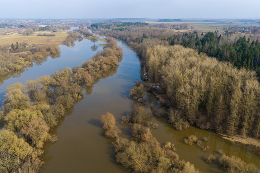 Aerial view of a winding river overflowing into surrounding forests and fields during spring floods Kaniukai Kaunas County Lithuania. Aerial view of a winding river overflowing into surrounding forests and fields during spring floods Kaniukai Kaunas County Lithuania.