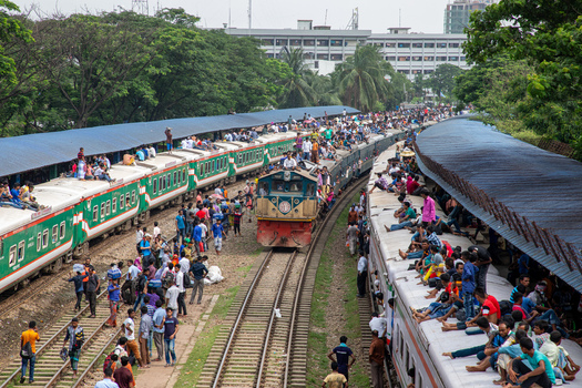 Dhaka Bangladesh 14 June 2018 View of the Airport Railway Station with overcrowded trains and people sitting on the roofs during a busy commute. Dhaka Bangladesh 14 June 2018 View of the Airport Railway Station with overcrowded trains and people sitting on the roofs during a busy commute.