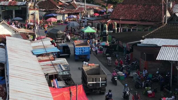 Aerial view of a busy street market with trucks and people Indonesia. Aerial view of a busy street market with trucks and people Indonesia.