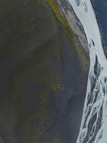 Aerial view of Skyggnisvatn featuring glacial river channels winding through dark volcanic terrain and mossy slopes in Hella Rangarthing ytra Iceland. Aerial view of Skyggnisvatn featuring glacial river channels winding through dark volcanic terrain and mossy slopes in Hella Rangarthing ytra Iceland.