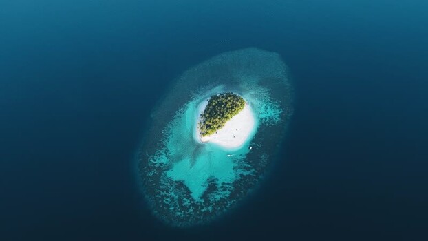 Aerial view of a tropical island and coral reef in Maldives. Aerial view of a tropical island and coral reef in Maldives.