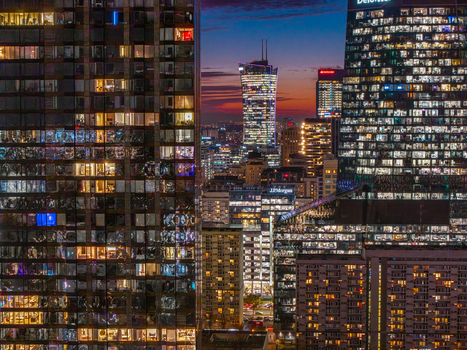 Aerial view of illuminated skyscrapers and the Varso Tower during twilight in the city center of Warsaw Poland. Aerial view of illuminated skyscrapers and the Varso Tower during twilight in the city center of Warsaw Poland.