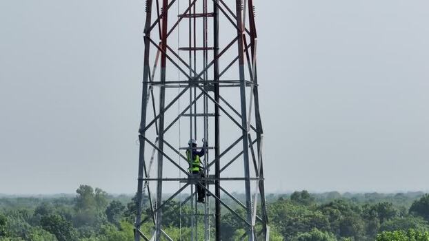 Aerial view of a technician climbing a cell tower Bangladesh.
