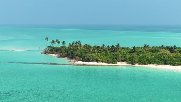 Aerial view of a tropical island and turquoise water Maldives.
