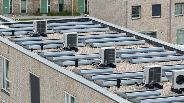 Aerial view of modern heat pump units and skylights on a gravel flat roof of a residential building Almere Flevoland Netherlands. Aerial view of modern heat pump units and skylights on a gravel flat roof of a residential building Almere Flevoland Netherlands.