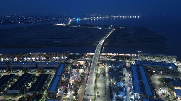 Aerial view of Golf Island in PIK at night with illuminated bridge modern buildings and coastal infrastructure in Kecamatan Penjaringan Daerah Khusus Ibukota Indonesia. Aerial view of Golf Island in PIK at night with illuminated bridge modern buildings and coastal infrastructure in Kecamatan Penjaringan Daerah Khusus Ibukota Indonesia.