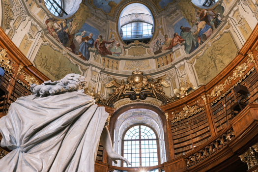 Vienna Austria 26 April 2026 View of the Austrian National Library showing the ornate Baroque Prunksaal with its grand dome frescoes wooden bookshelves and marble statues. Vienna Austria 26 April 2026 View of the Austrian National Library showing the ornate Baroque Prunksaal with its grand dome frescoes wooden bookshelves and marble statues.