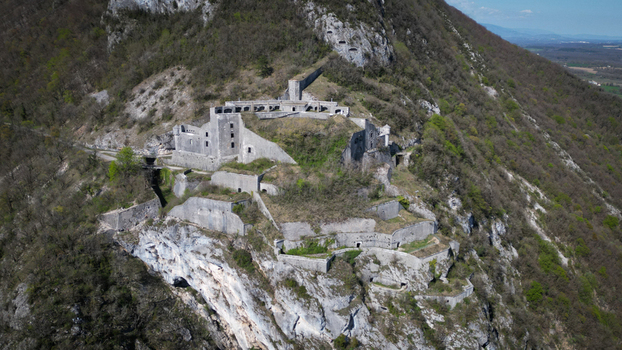 Aerial view of the ancient fort nestled on the steep rocky slopes its weathered stones blending with the rugged terrain L&eacute;az Auvergne Rh&ocirc;ne Alpes France.
