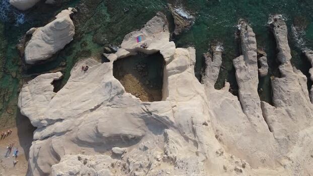 Aerial view of white coastal cliffs and sea caves in Cyprus.