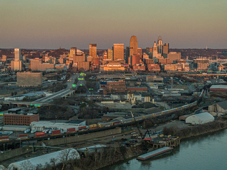 Aerial view of a city skyline bathed in the warm glow of the setting sun highlighting the contrasting textures of buildings and the river Cincinnati Ohio United States. Aerial view of a city skyline bathed in the warm glow of the setting sun highlighting the contrasting textures of buildings and the river Cincinnati Ohio United States.