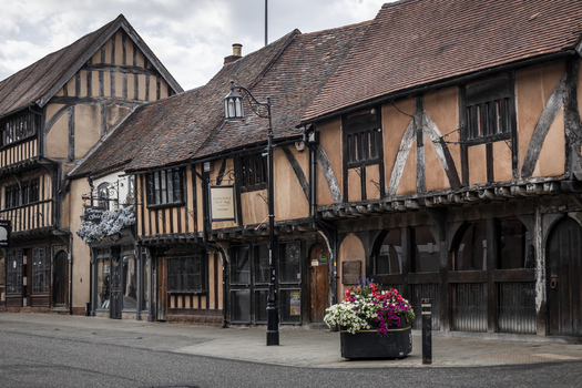 Coventry United Kingdom 20 July 2026 View of historic timber framed buildings in Spon Street with dark wood beams tiled roofs and a flower planter on the sidewalk.
