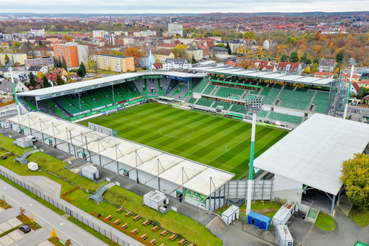 Furth Germany 02 May 2026 Aerial view of Sportpark Ronhof Thomas Sommer stadium featuring green stands and a manicured pitch surrounded by the urban cityscape and autumn foliage.