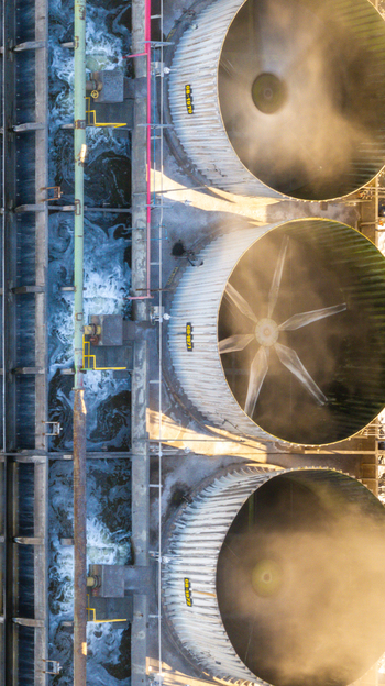 Aerial view of large industrial cooling towers with rotating fans and water channels at a petrochemical complex in Santo Andre State of Sao Paulo Brazil.